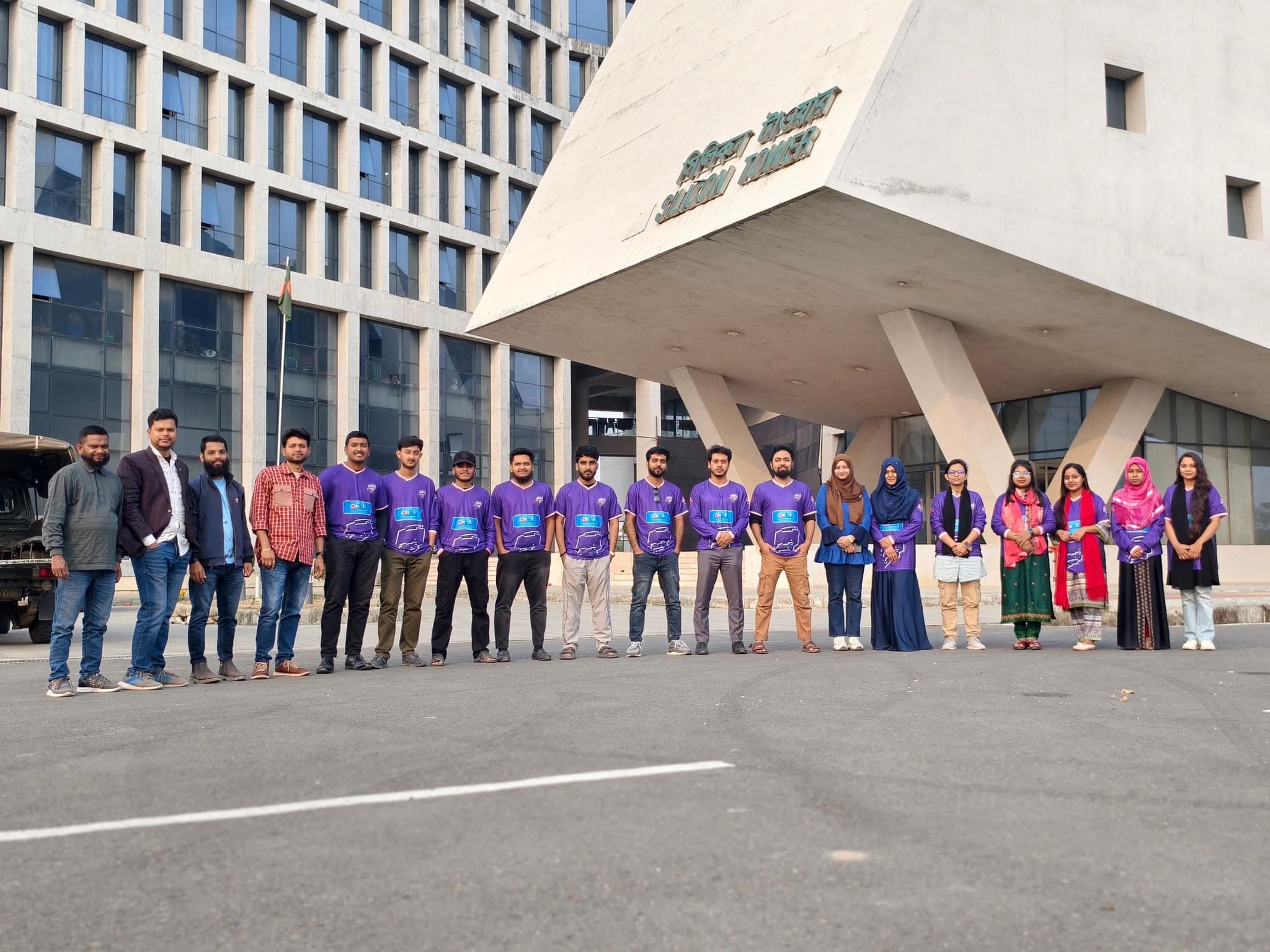 The team outside the office in matching shirts
